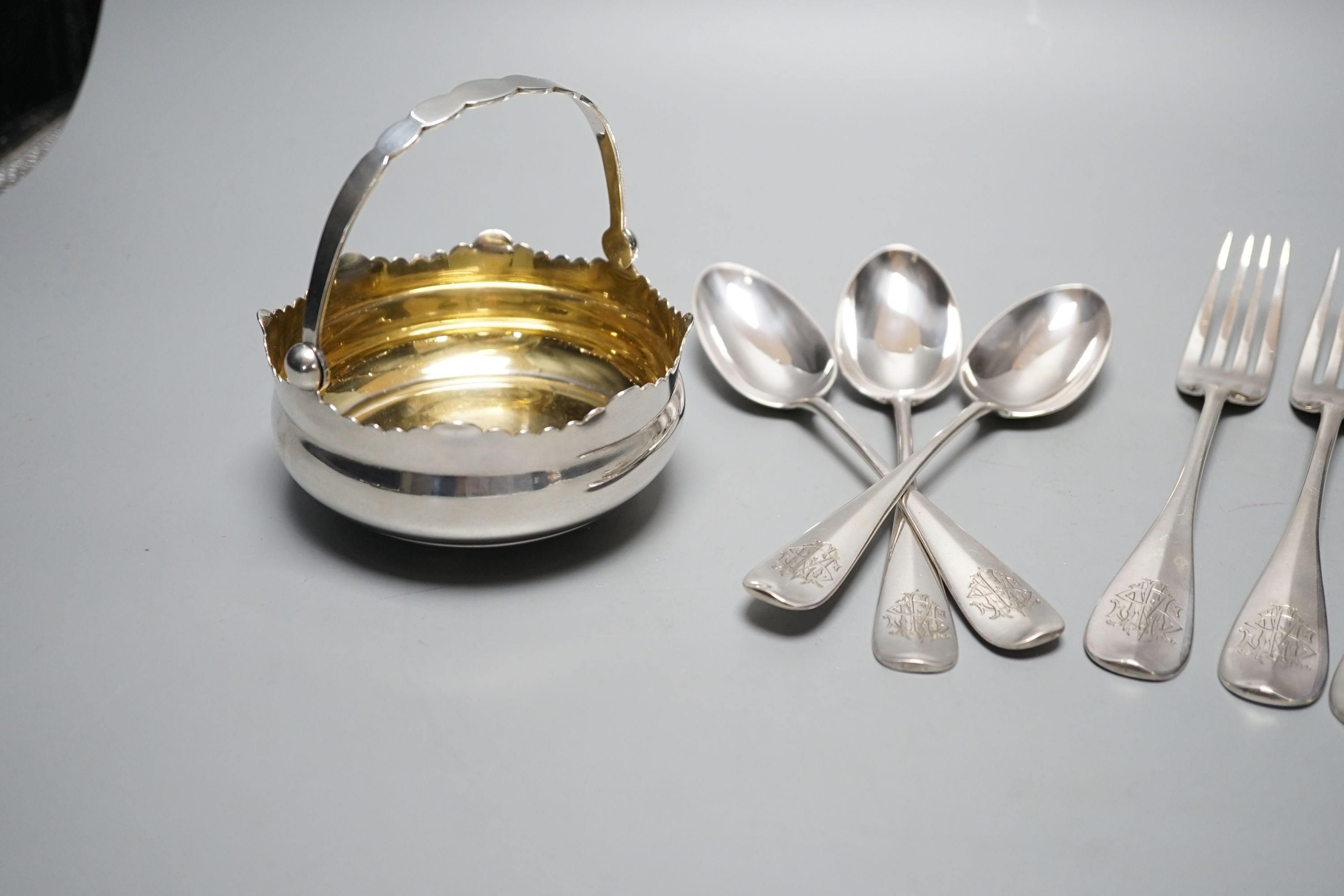 An early 20th century Russian .875 standard white metal bonbon basket, Odessa, 1908-1926, diameter 10.2cm, together with three late 19th century Russian 84 zolotnik table forks and three dessert spoons, master Klebnikov,